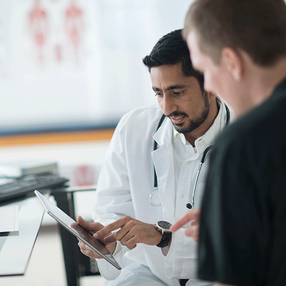 Doctor and patient looking at tablet