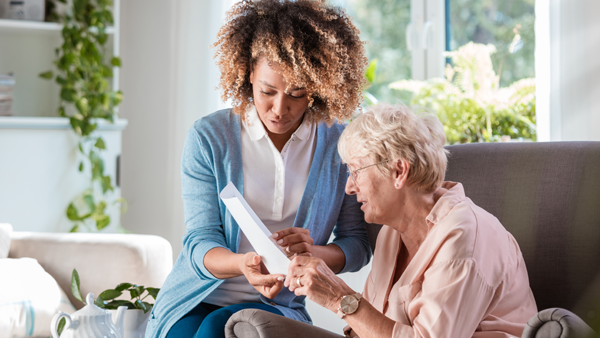 Home nurse taking care of senior woman