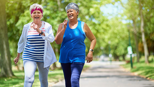 Shot of two elderly friends enjoying a run together outdoors