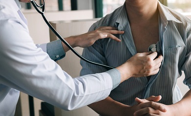 A doctor examines a patient with a stethoscope